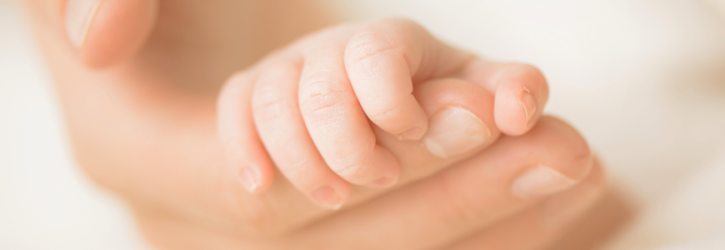 Baby holding finger