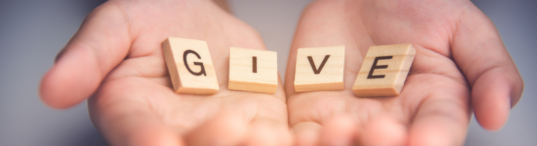 Hands open to reveal the word give