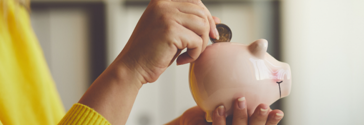 Putting money in piggy bank
