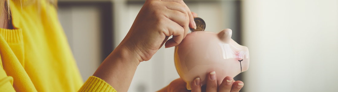 Putting money in piggy bank