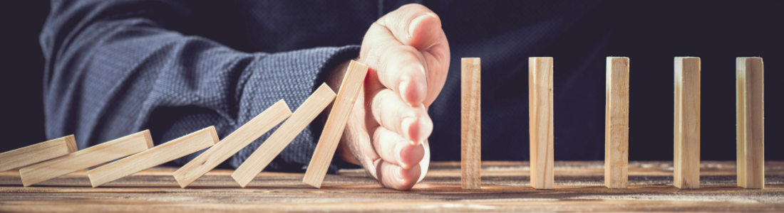 Hand preventing dominoes tumbling