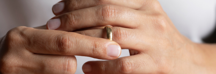Person removing their wedding ring