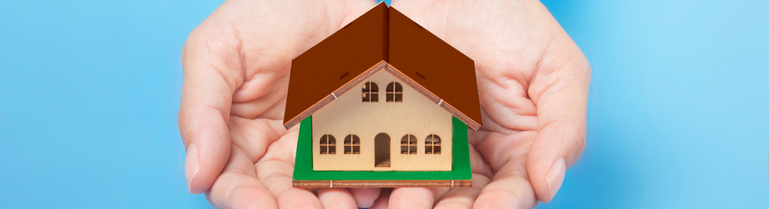 Cupped hands giving small house away