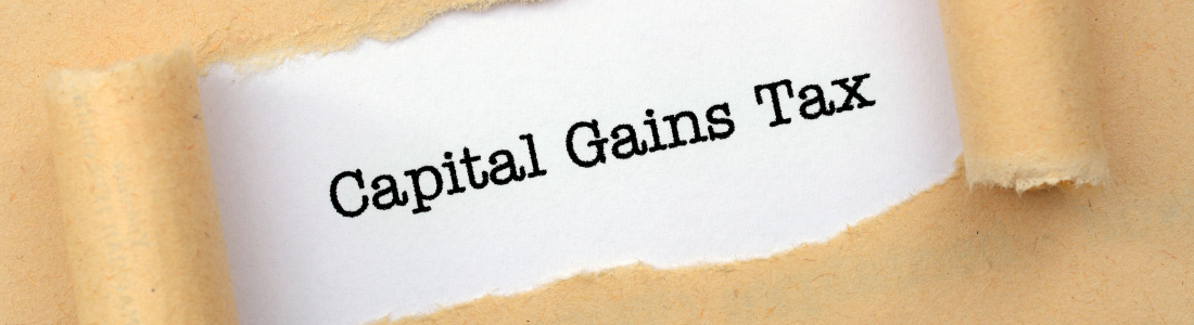 The words Capital Gains Tax appearing through a torn envelope