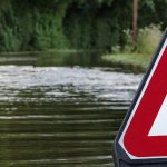 Canoeist on flooded road