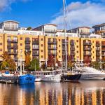 Waterside apartments witth boats in foreground