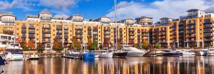 Waterside apartments witth boats in foreground