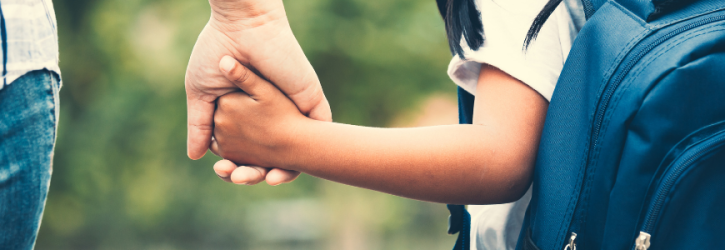 Parent holding child's hand
