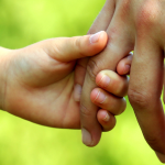 Parent and child holding hands