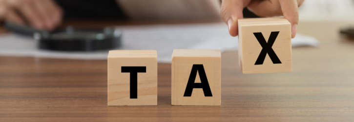 The word TAX in wooden blocks