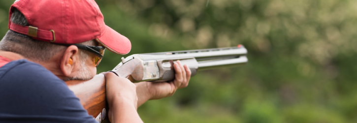 Man with shotgun enjoying sporting rights on rural land