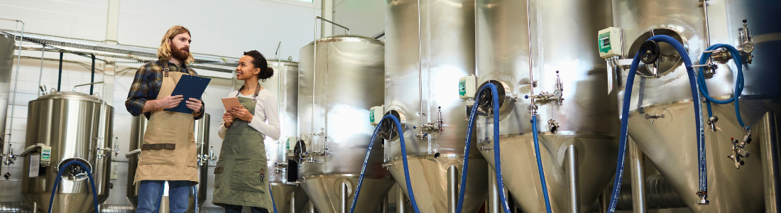 Couple standing in their small brewery keen to futureproof their business